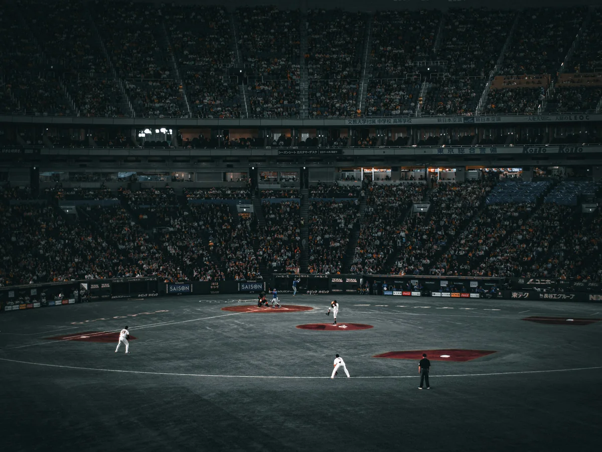 The Tokyo Dome infield and packed stands during a night game, seen from behind home plate
